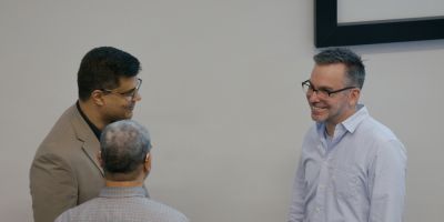 Three people discussing