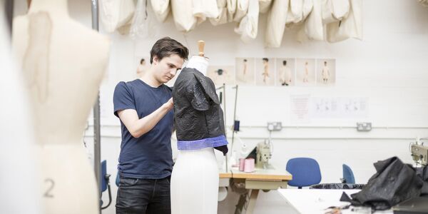 Design student working on mannequin in school facilities