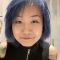profile photograph of student with blue short hair wearing black sleeveless zip up top