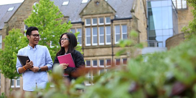 Two students walking through campus.